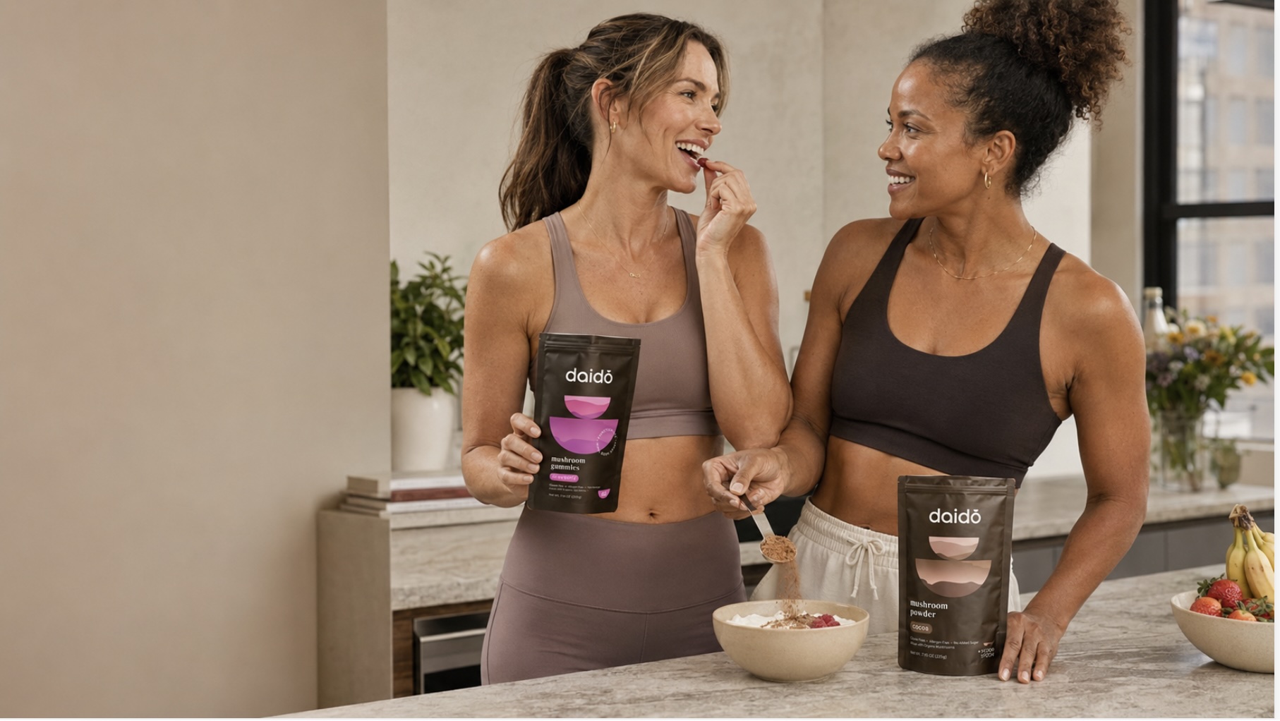 Two women enjoying daido gummies and functional blend cocoa in a kitchen